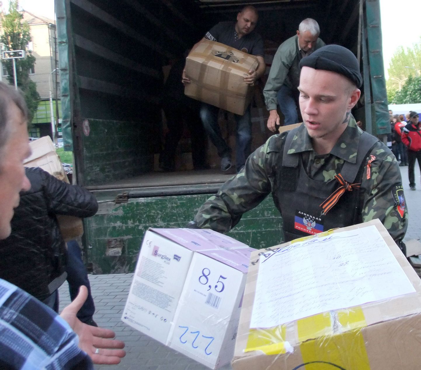 Georgi lindikesi ja olematu Donetski rahvavabariigi tunnused kandvad venemeelsed jagavad Venemaa saadetud humanitaarabi.