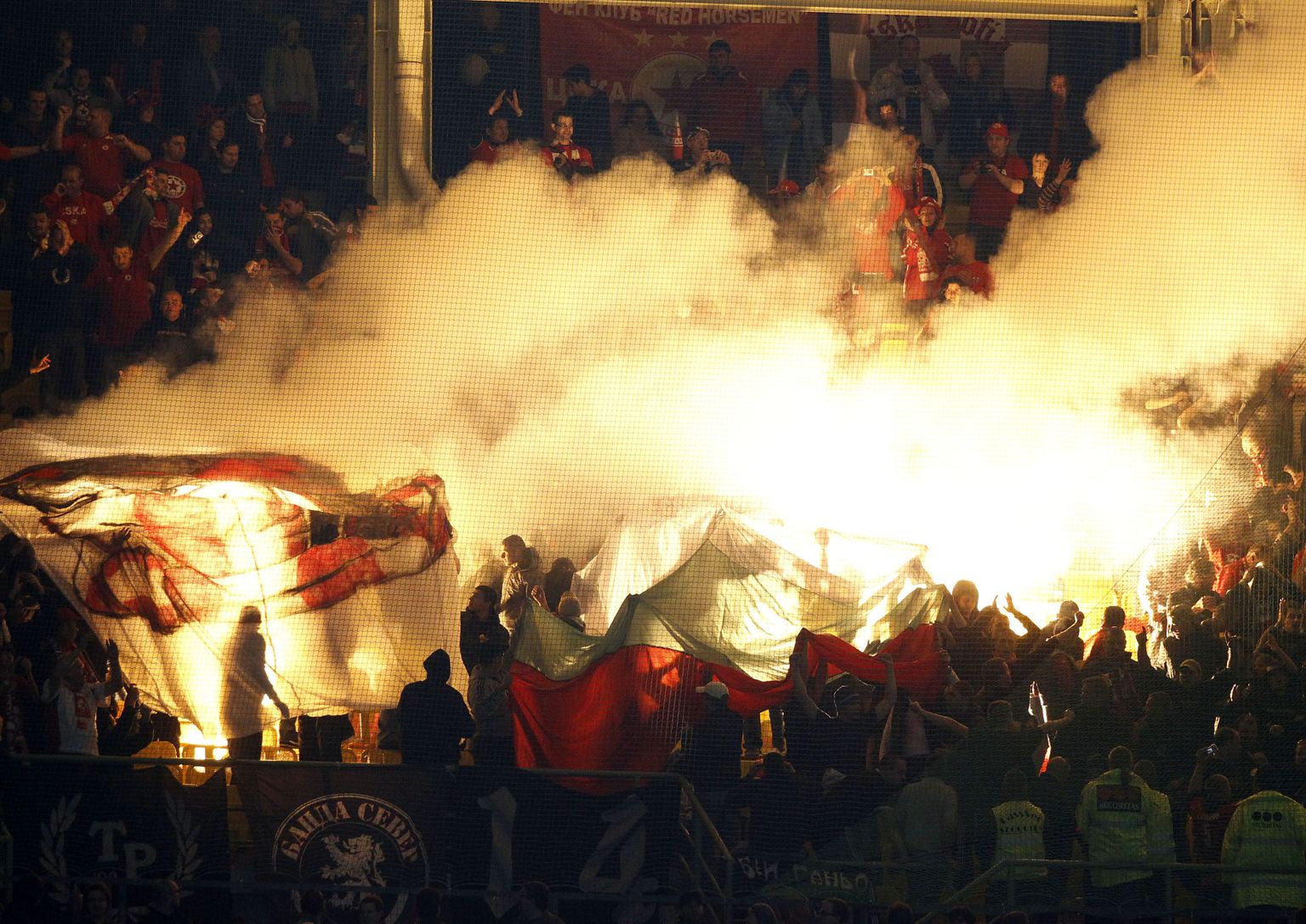 Supporters of CSKA Sofia light fireworks during their Europa League group L soccer match against Rapid Wien at Happelstadion in Vienna November 4, 2010. REUTERS/Robert Zolles (AUSTRIA - Tags: SPORT SOCCER)