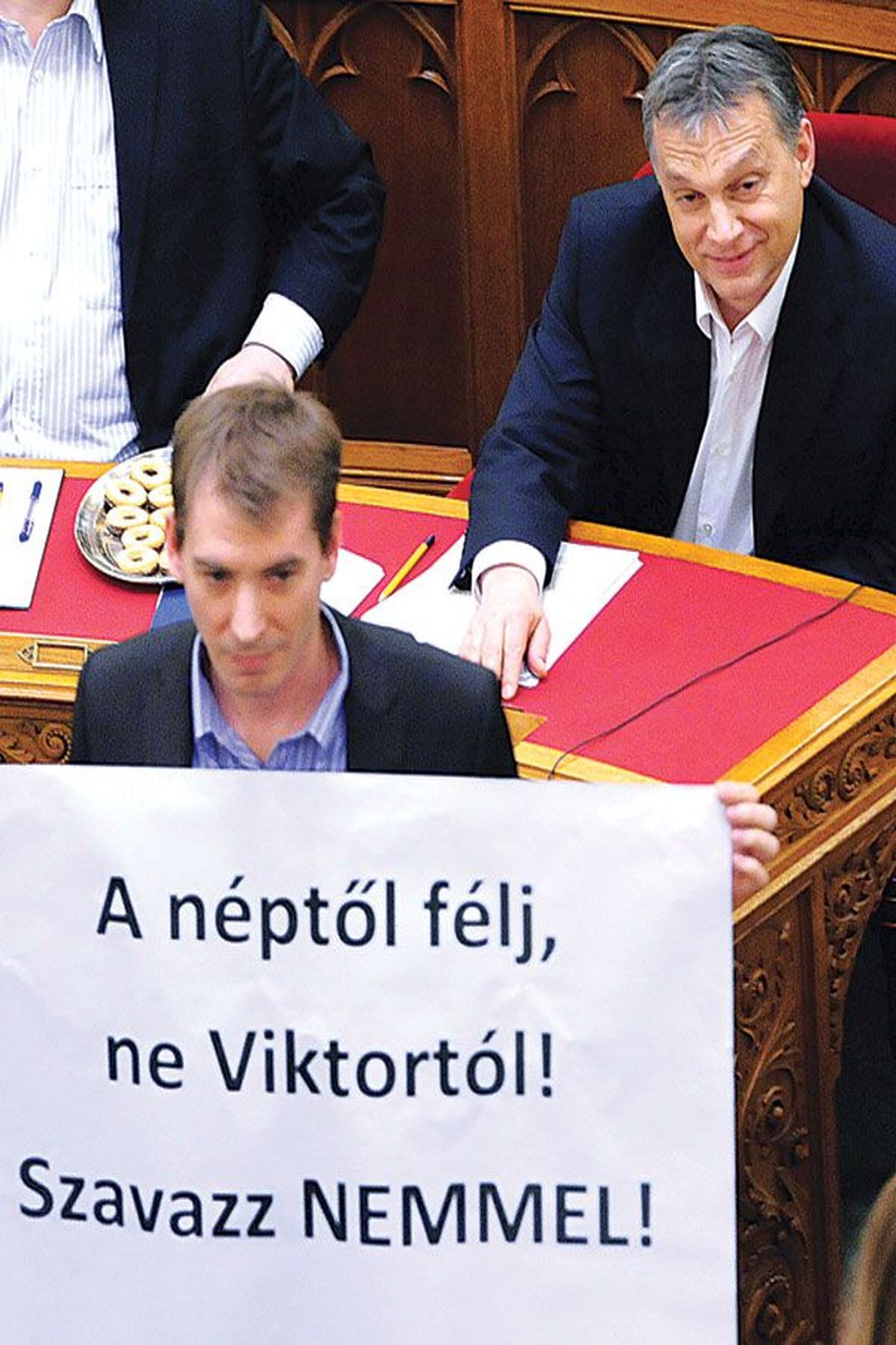 Вынесенный в понедельник из здания парламента плакат, который призывает голосовать против изменения Конституции. Премьер-министр Виктор Орбан (на фото справа) добился желаемых изменений.