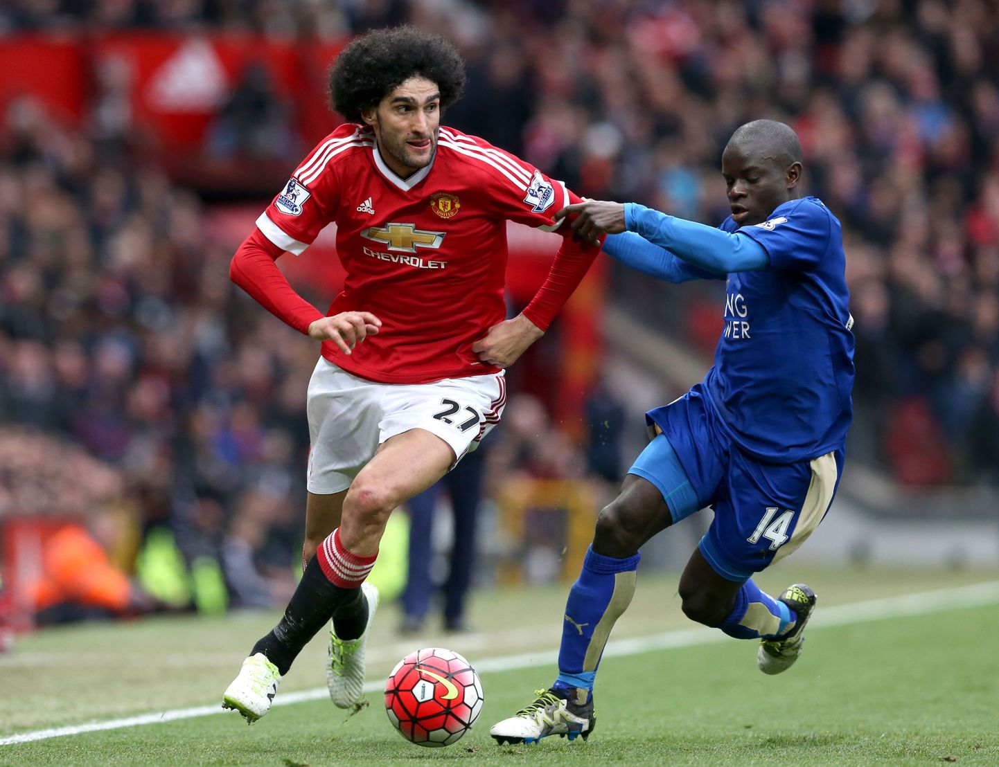 Manchester United's Marouane Fellaini, left, and Leicester City's N'Golo Kante chase the ball during their  English Premier League soccer match at Old Trafford, Manchester, Sunday May 1, 2016. (Martin Rickett / PA via AP) UNITED KINGDOM OUT - NO SALES - NO ARCHIVES