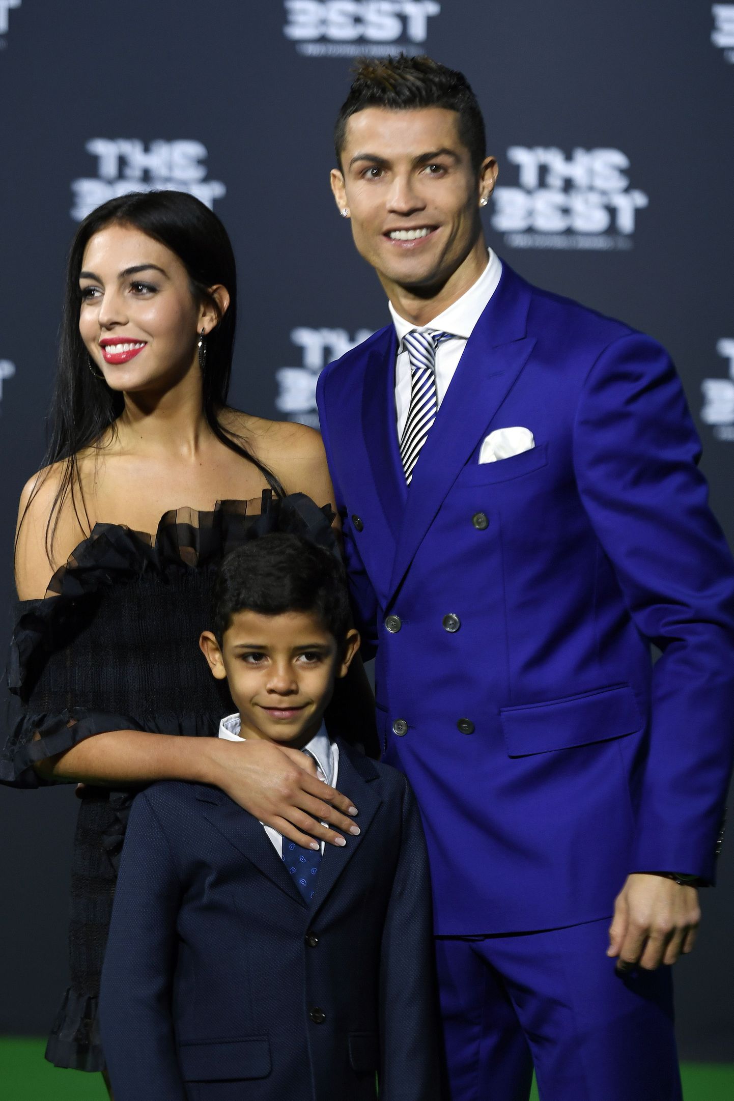Portugal's soccer player Cristiano Ronaldo, right, his girlfriend Georgina Rodriguez, left, and his son Ronaldo jr., center, arrive on the green carpet prior during the The Best FIFA Football Awards 2016 ceremony held at the Swiss TV studio in Zurich, Switzerland, Monday, Jan. 9, 2017. (Walter Bieri/Keystone via AP)