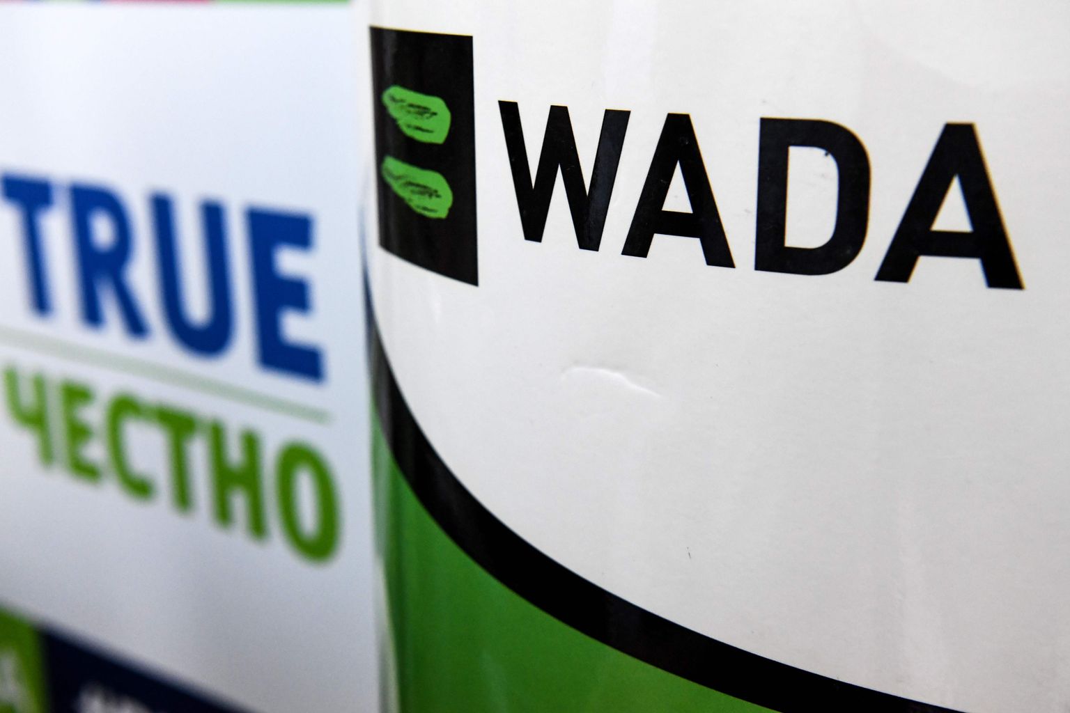 (FILES) In this file photo The World Anti-Doping Agency or WADA logo is pictured at the Russkaya Zima (Russian Winter) Athletics competition in Moscow on February 9, 2020. - The World Anti-Doping Agency (WADA) said April 30,2020 it has handed over the results of its investigations into hundreds of Russian athletes probed for doping offences to international federations for possible further action. WADA said in a statement it had provided case packages on 298 athletes to 29 anti-doping organisations, 27 international federations and one major event organisation. (Photo by Kirill KUDRYAVTSEV / AFP)