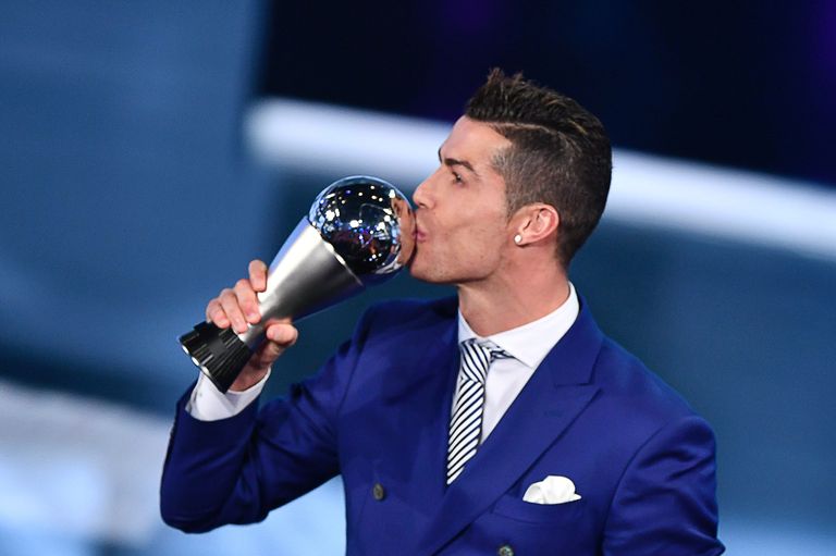 Real Madrid and Portugal's forward Cristiano Ronaldo kisses his trophy after winning the The Best FIFA Men