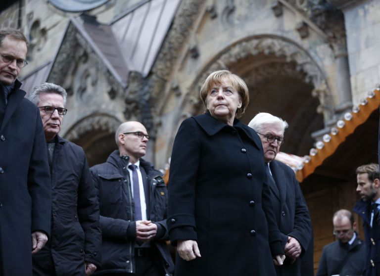 German Chancellor Angela Merkel and German Foreign Minister Fank-Walter Steinmeier walk towards the Christmas market in Berlin, Germany, December 20, 2016, one day after a truck ploughed into a crowded Christmas market in the German capital.       REUTERS/Hannibal Hanschke    TPX IMAGES OF THE DAY