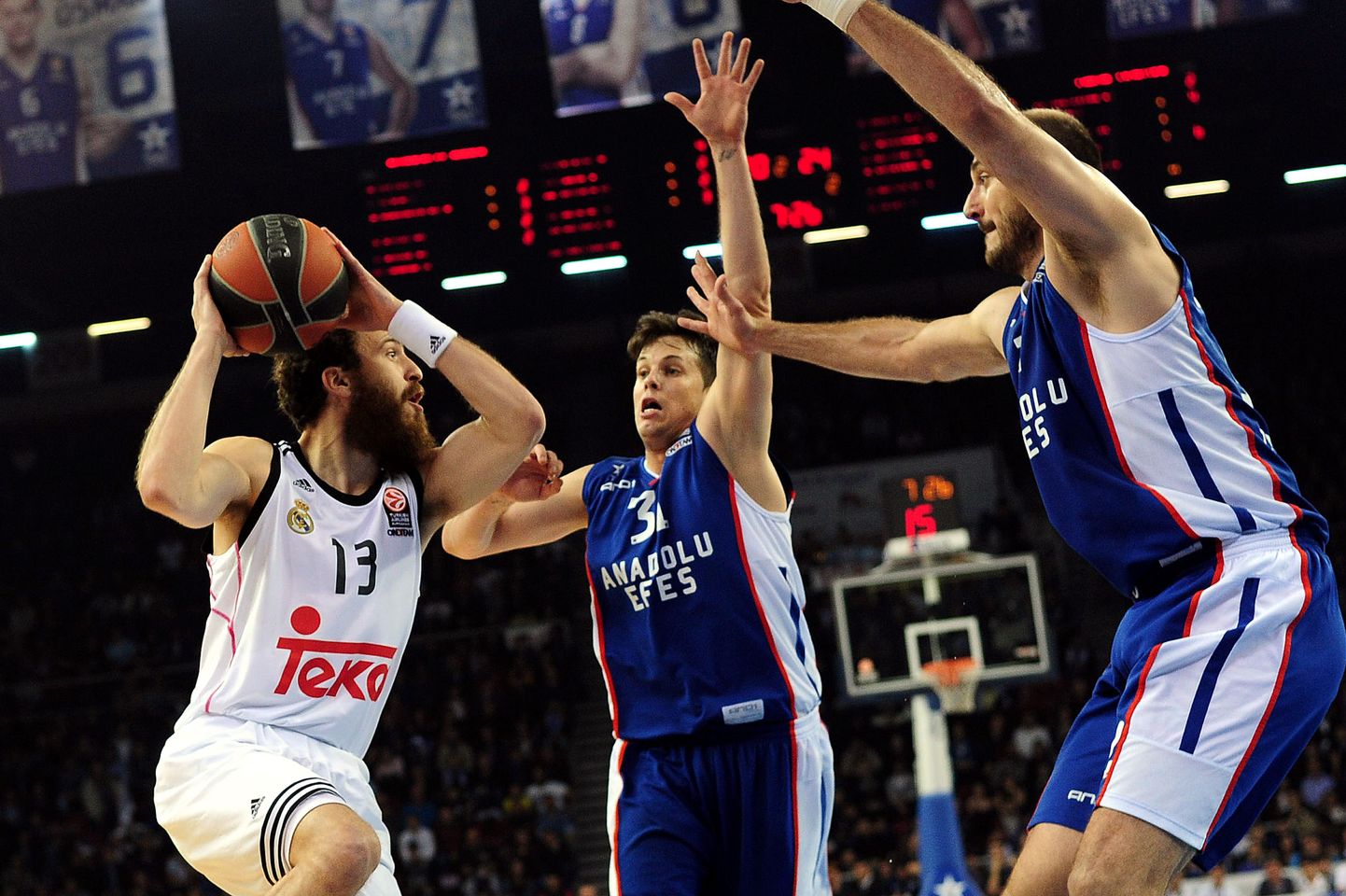 Real Madrid's guard Sergio Rodriguez (L) vies with Anadolu Efes's Serbian guard Nenad Krstic (R) and French guard Thomas Heurtel (C) during the Euroleague playoffs round 3 basketball match between Anadolu Efes and Real Madrid at Abdi Ipekci Arena in Istanbul on April 21, 2015. AFP PHOTO / OZAN KOSE