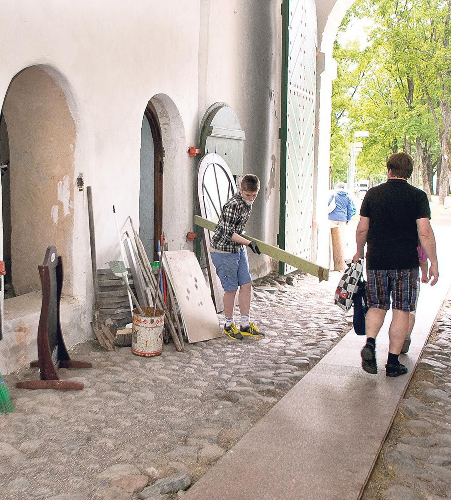 Tallinna värava võlvi all töötavad Pärnu muuseumi õpilasmalevlased, et võlvialused vahtkonnaruumid näeksid head välja, kui nad seal suvel giididena tööle hakkavad.