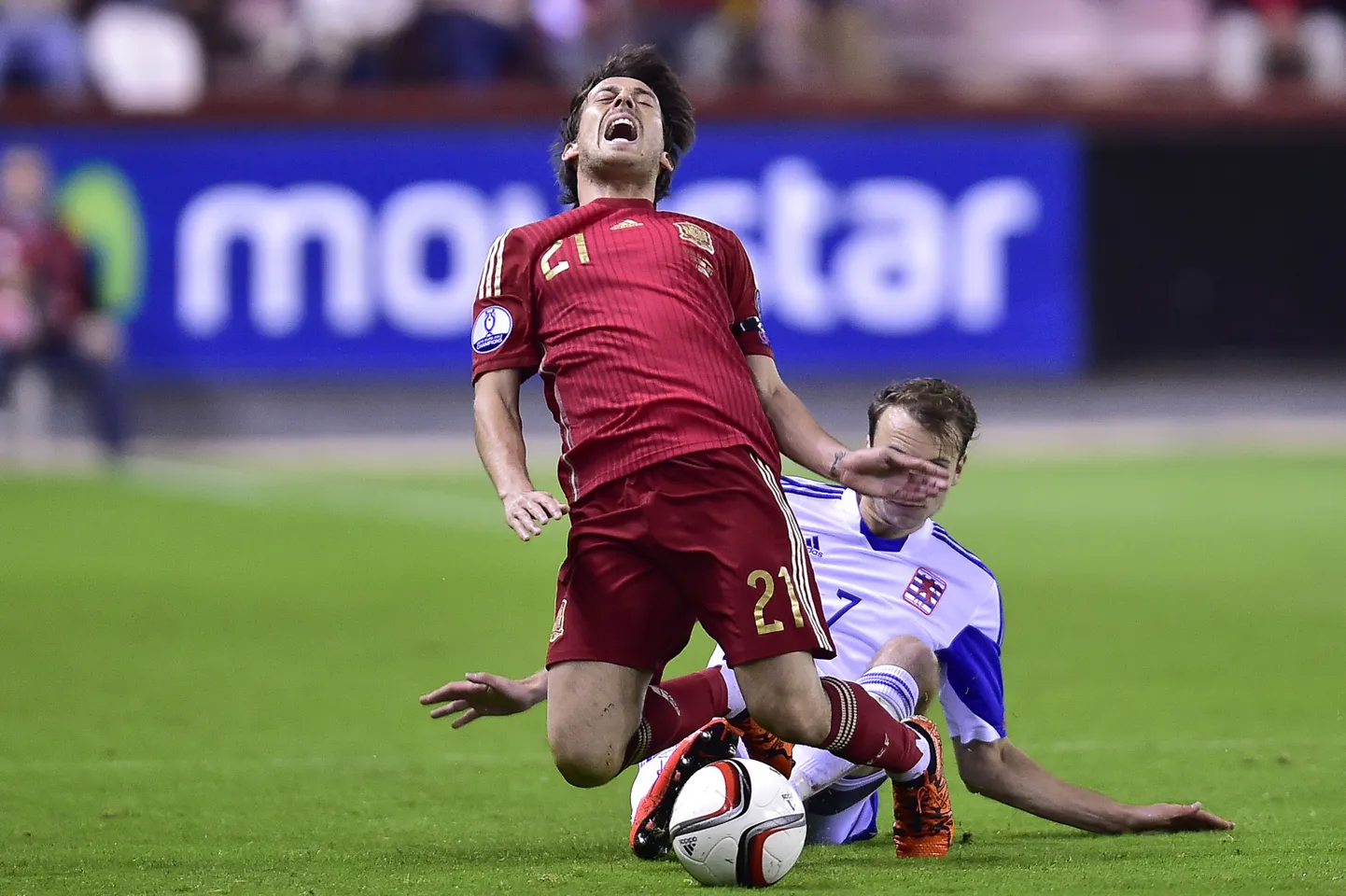 Spain's David Silva, left is tackled Luxembourg's Lars Gerson, during their Euro 2016 qualifying soccer match, Group C,  between Spain and Luxembourg,  at Las Gaunas  stadium in Logrono, northern Spain, Friday, Oct. 9, 2015. (AP Photo/Alvaro Barrientos)