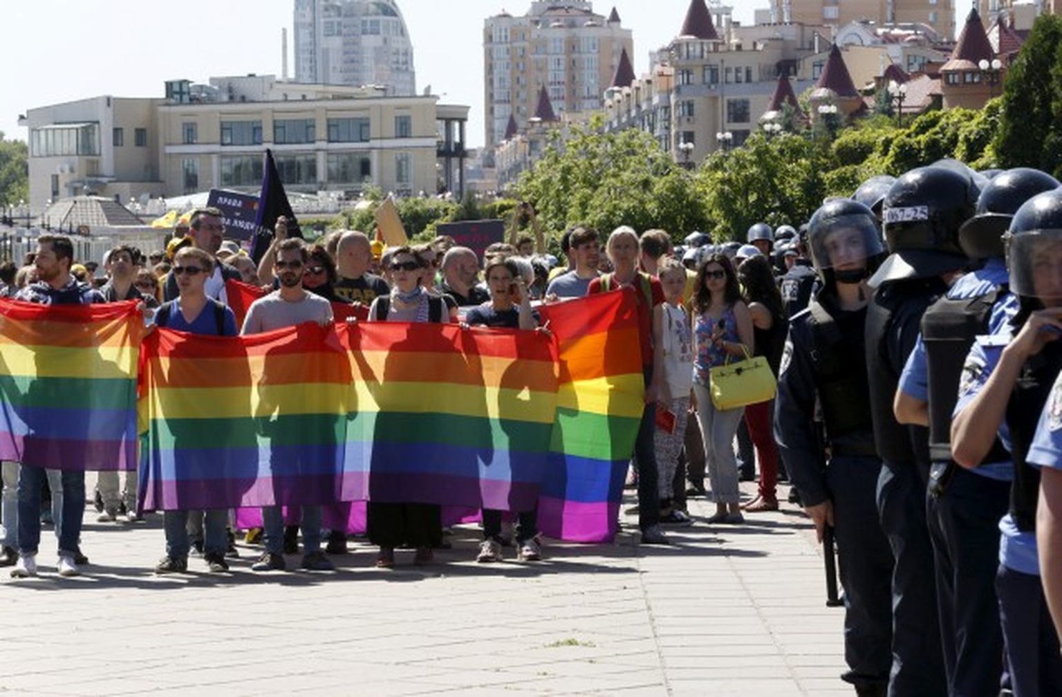 Interior Ministry members stand guard as activists take part in a march organized by LGBT community in Kiev