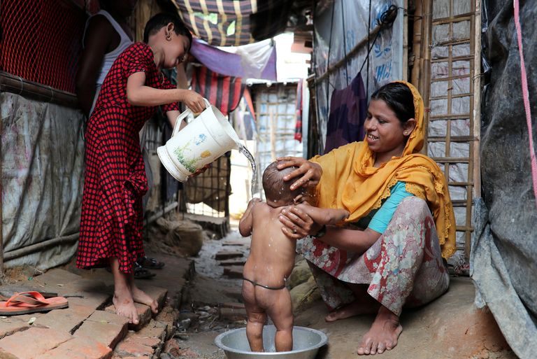 Ema vannitab oma last põgenikelaagris Bangladeshis. 