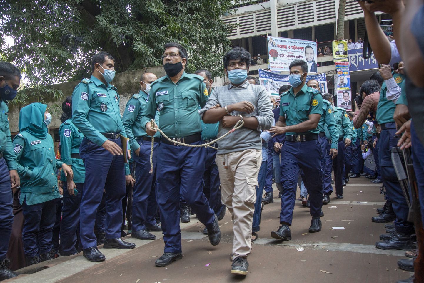 Bangladeshi politseinikud mõrvas süüdistatuid eskortimas.