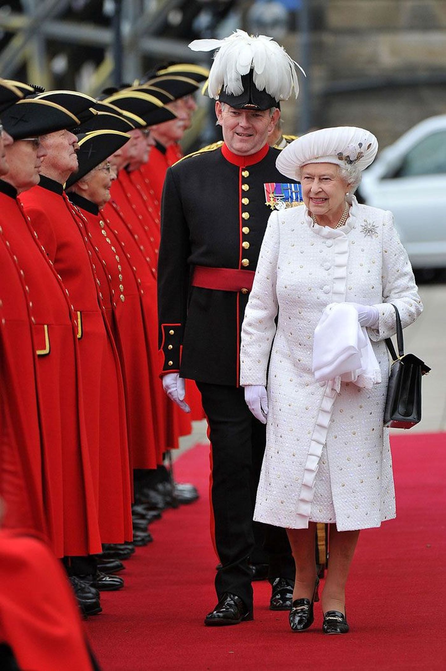 Kuuskümmend aastat võimul: kuninganna Elizabeth II troonijuubeli pidustustel – pidulikult valges. Pärlid ja pross ning mustad kingad ja ridikül kuuluvad tema garderoobi raudvarasse.