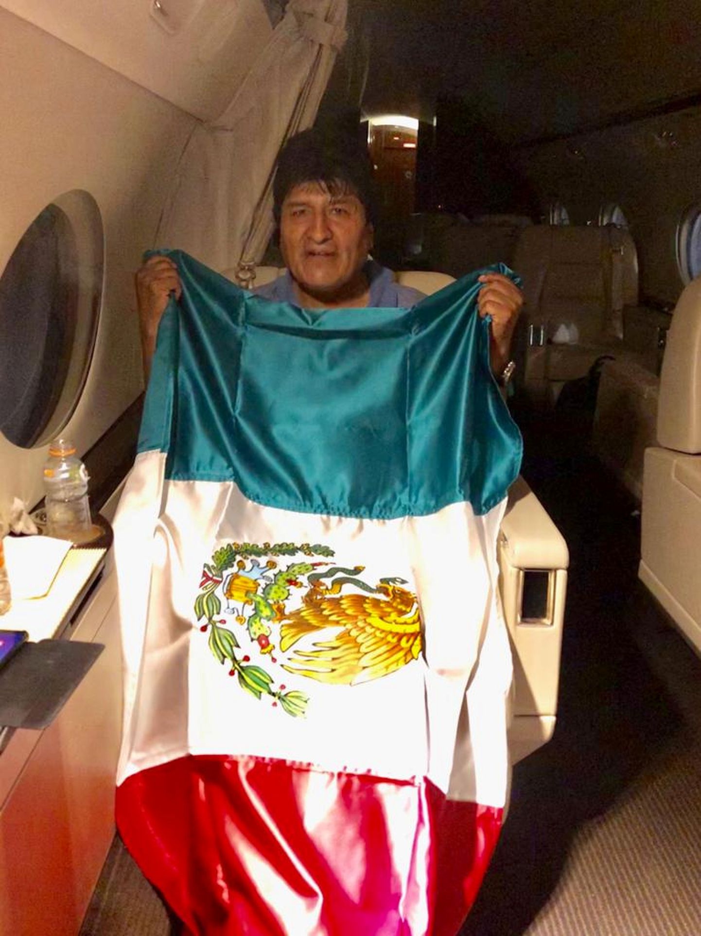Former Bolivian President Evo Morales holds a Mexican flag onboard a Mexican government's aircraft in an unidentified location  November 11, 2019.   Mexican Foreign Minister Marcelo Ebrard via Twitter via REUTERS  ATTENTION EDITORS - THIS IMAGE HAS BEEN SUPPLIED BY A THIRD PARTY. MANDATORY CREDIT. NO RESALES. NO ARCHIVES.  TPX IMAGES OF THE DAY        REFILE - CORRECTING SOURCE.