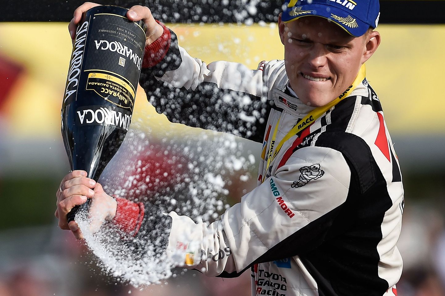 Estonian driver Ott Tanak celebrates with champagne on the podium as he won the 2019 FIA World Rally Championship after finishing second on the 55th Catalonia 2019 FIA World Rally Championship on October 27, 2019 in Salou, near Tarragona.
