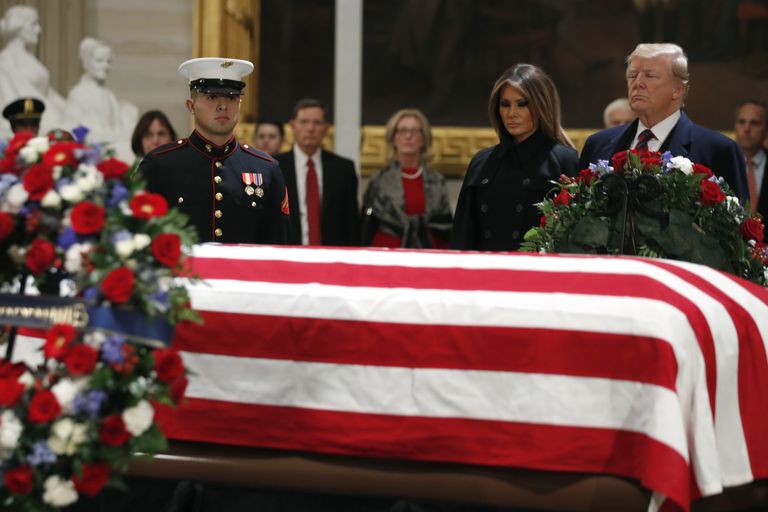 President Donald Trump and first lady Melania Trump pay their respects to former President George H. W. Bush, as he lies in state in the Rotunda of the U.S. Capitol, Monday, Dec. 3, 2018, in Washington. (AP Photo/Jacquelyn Martin)