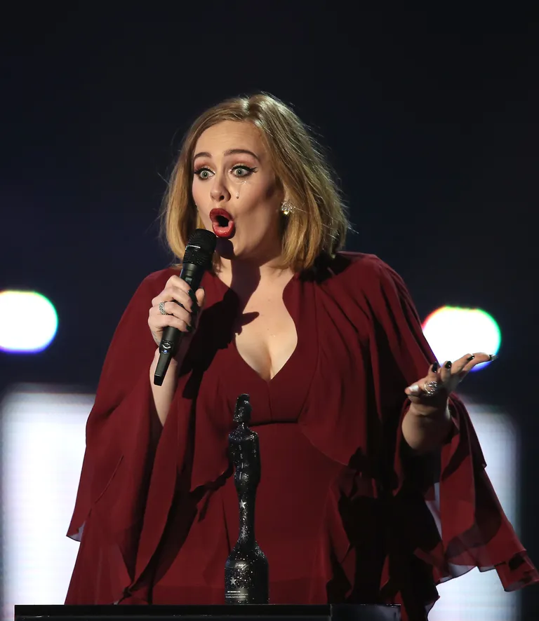 Singer Adele cries as she accepts the award for Global Success onstage at the Brit Awards 2016 at the 02 Arena in London, Wednesday, Feb. 24, 2016. (Photo by Joel Ryan/Invision/AP) Адель