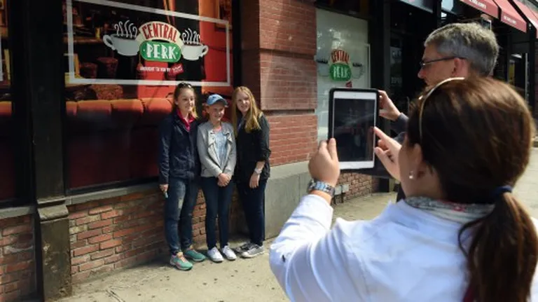 Tourists take photos outside a temporary