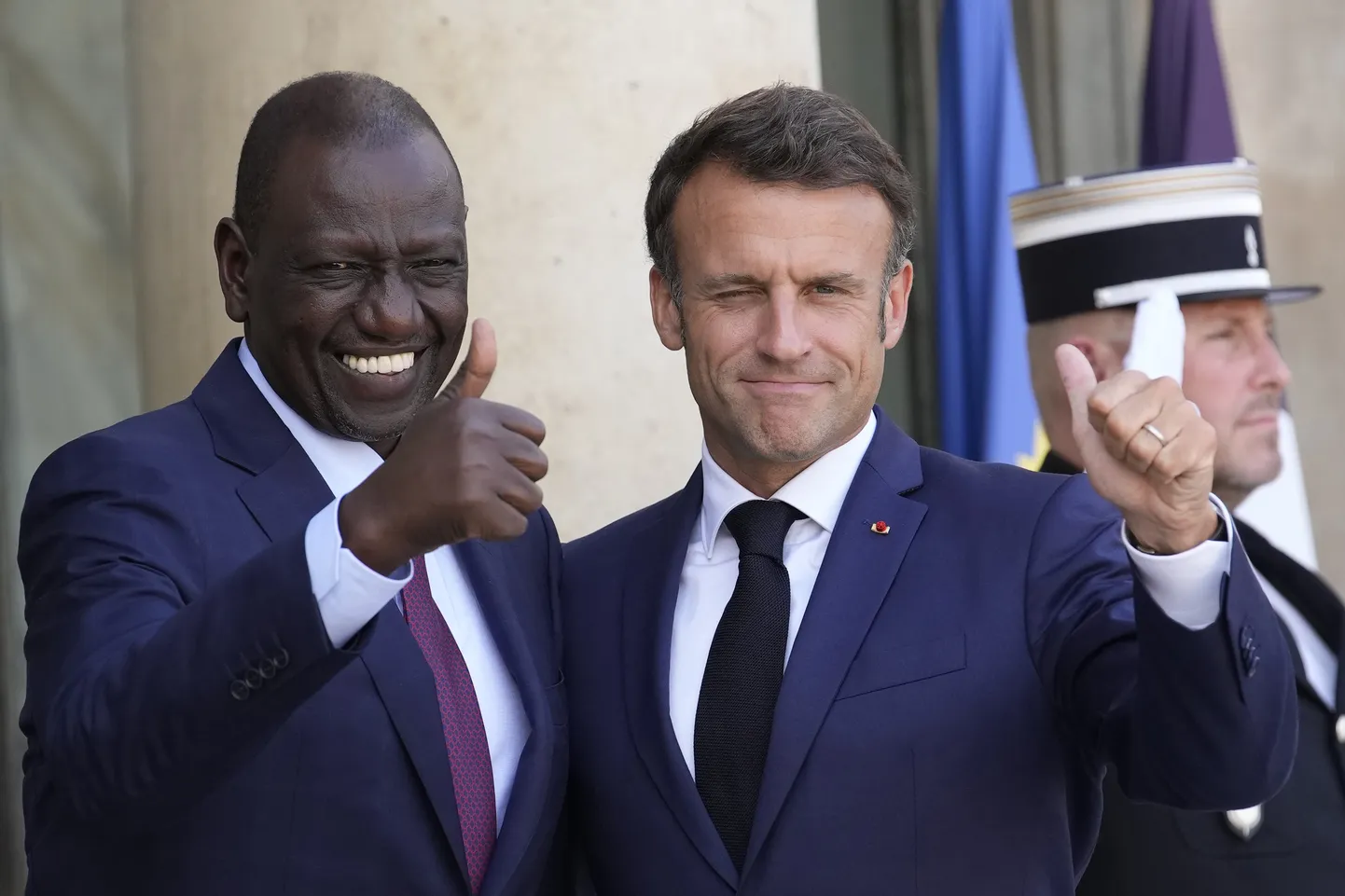 Президент Франции Эммануэль Макрон (справа) приветствует президента Кении Уильяма Руто.