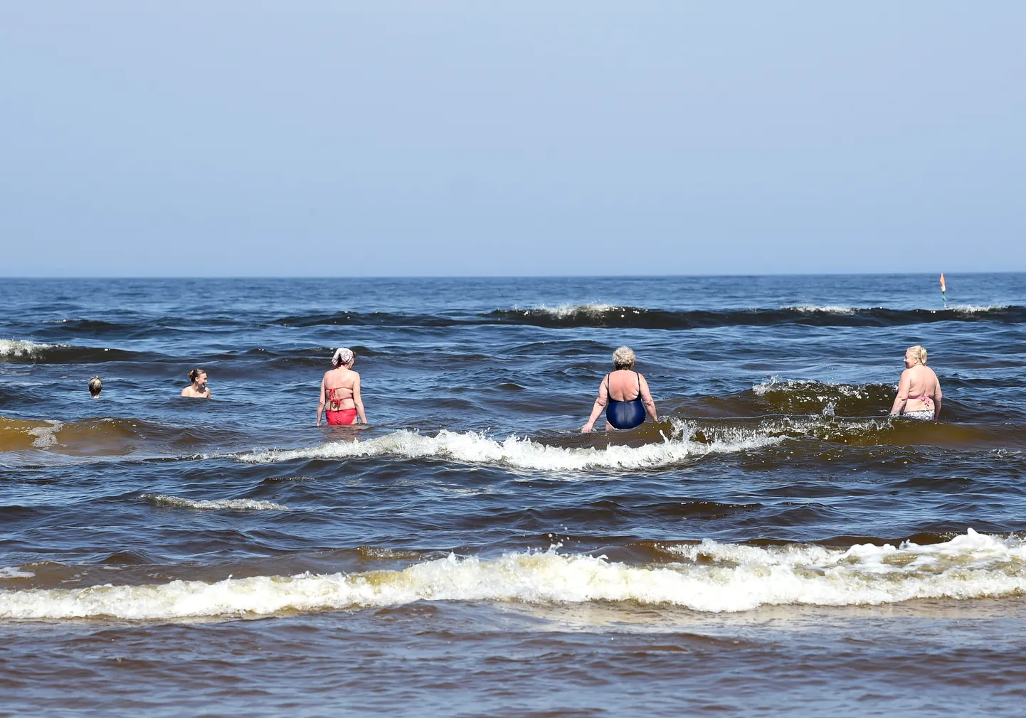 Cilvēki peldas Vecāķu pludmalē. Ilustratīvs attēls.