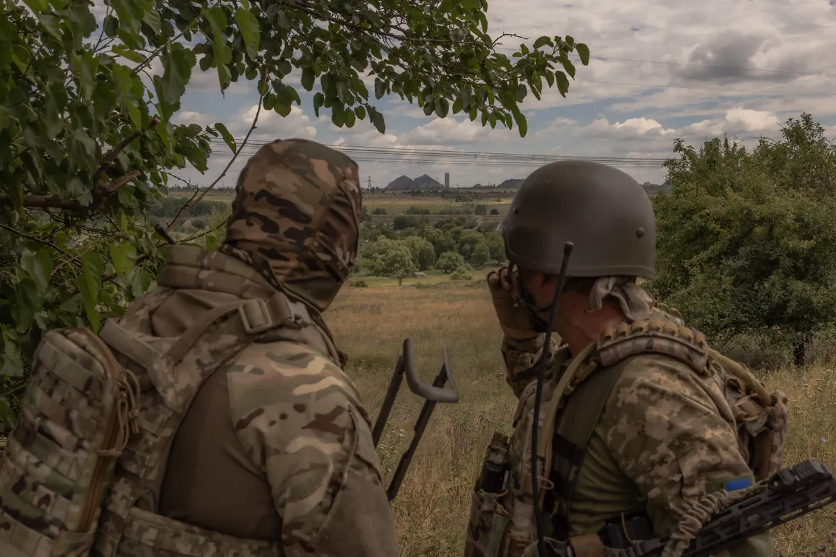 Ukrainian soldiers looking towards the city of Toretsk on June 25, 2024.