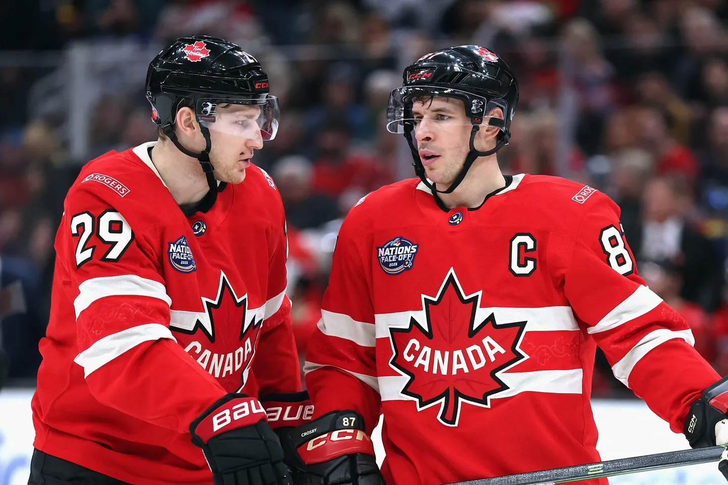 BOSTON, MASSACHUSETTS - FEBRUARY 17: Nathan MacKinnon #29 and Sidney Crosby #87 of Team Canada chat prior to a second period faceoff against Team Finland in the 4 Nations Face-Off game at TD Garden on February 17, 2025 in Boston, Massachusetts.   Maddie Meyer/Getty Images/AFP (Photo by Maddie Meyer / GETTY IMAGES NORTH AMERICA / Getty Images via AFP)