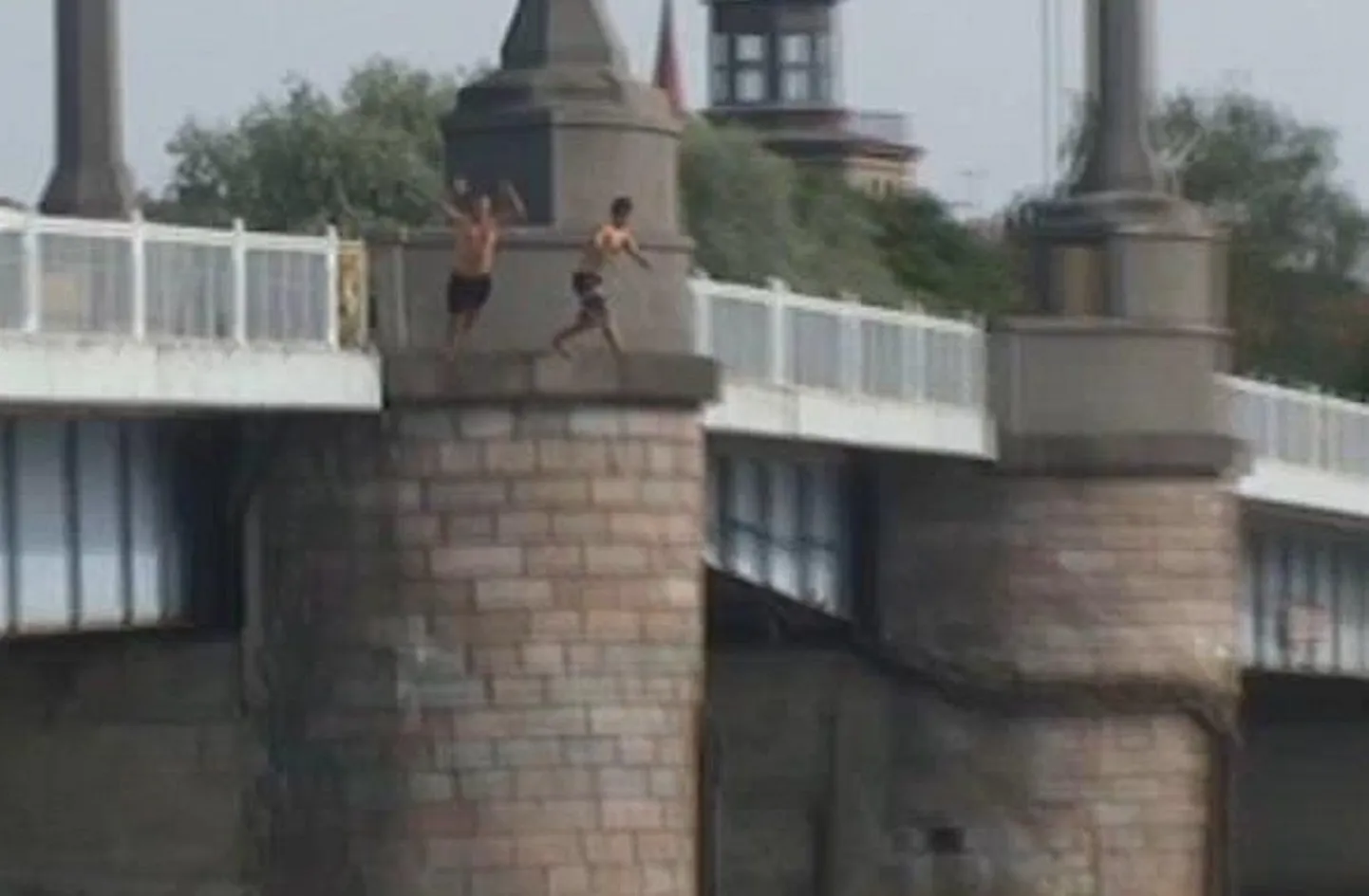 Kaader videost, kus kaks noormeest Pärnu kesklinna sillalt jõkke hüppavad.