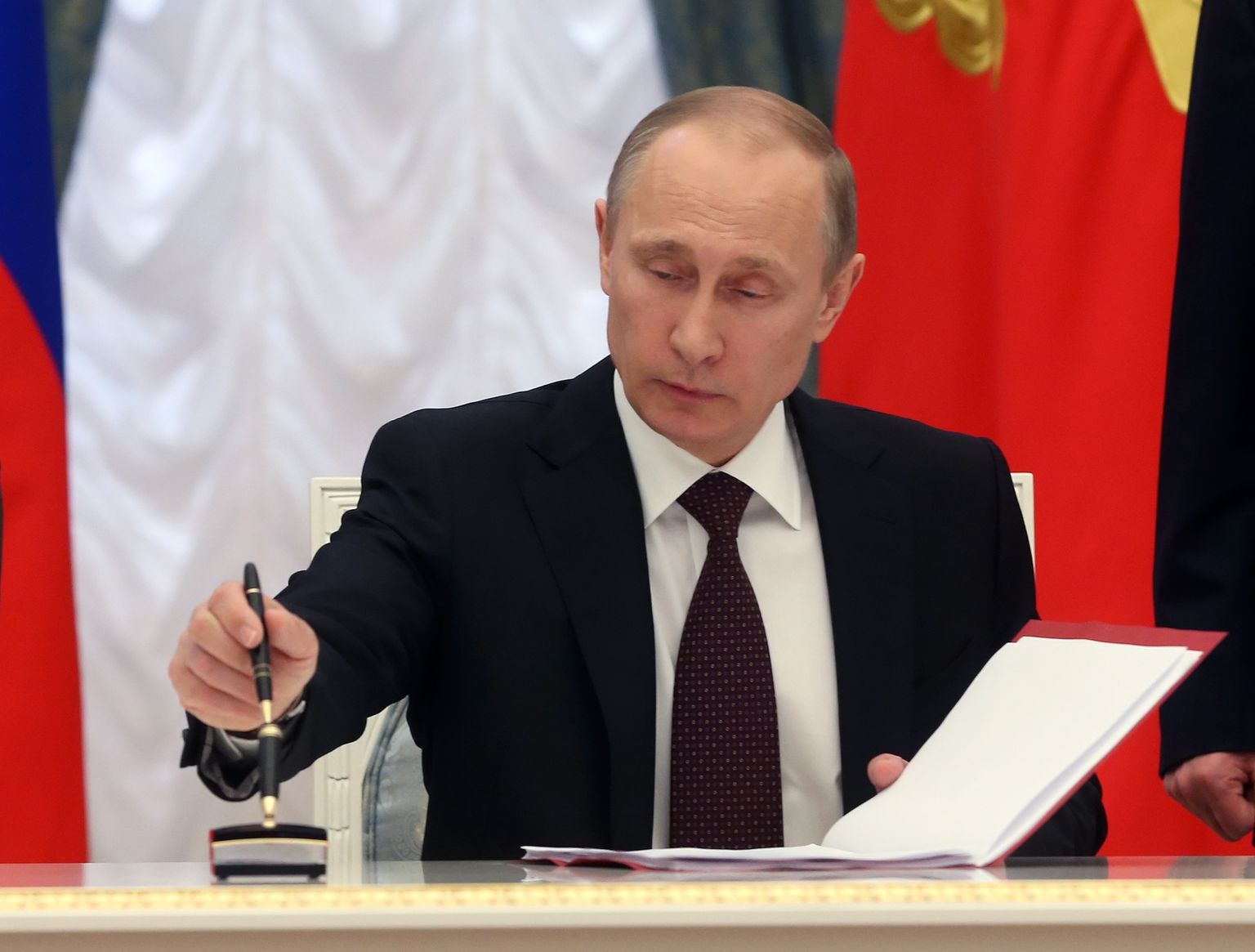 Venemaa president Vladimir Putin 21. märtsil 2014 Kremlis Krimmi Venemaa osaks kuulutavatele seaduseelnõudele alla kirjutamas.