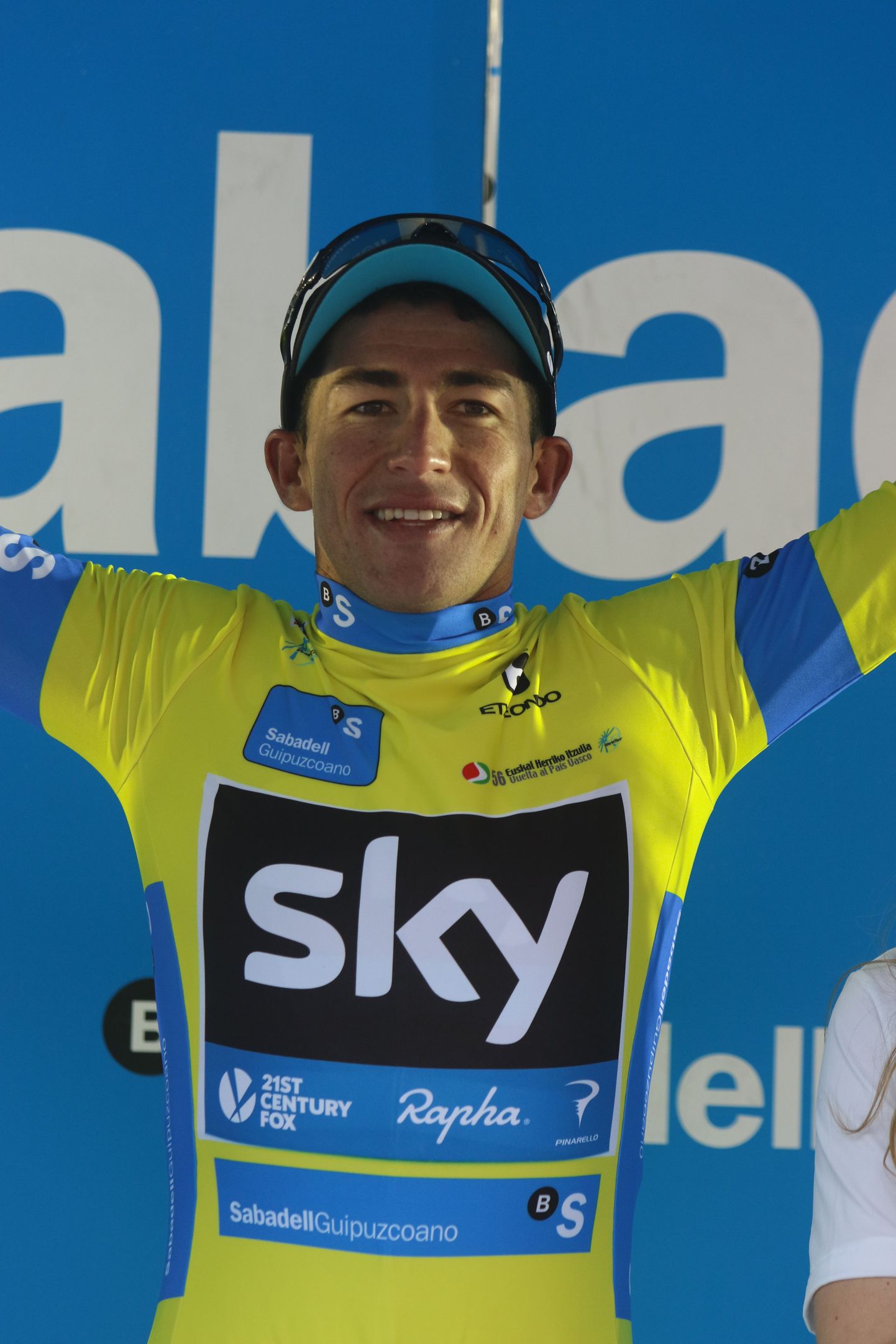 Sergio Henao of team Sky celebrates on the podium after taking the yellow jersey