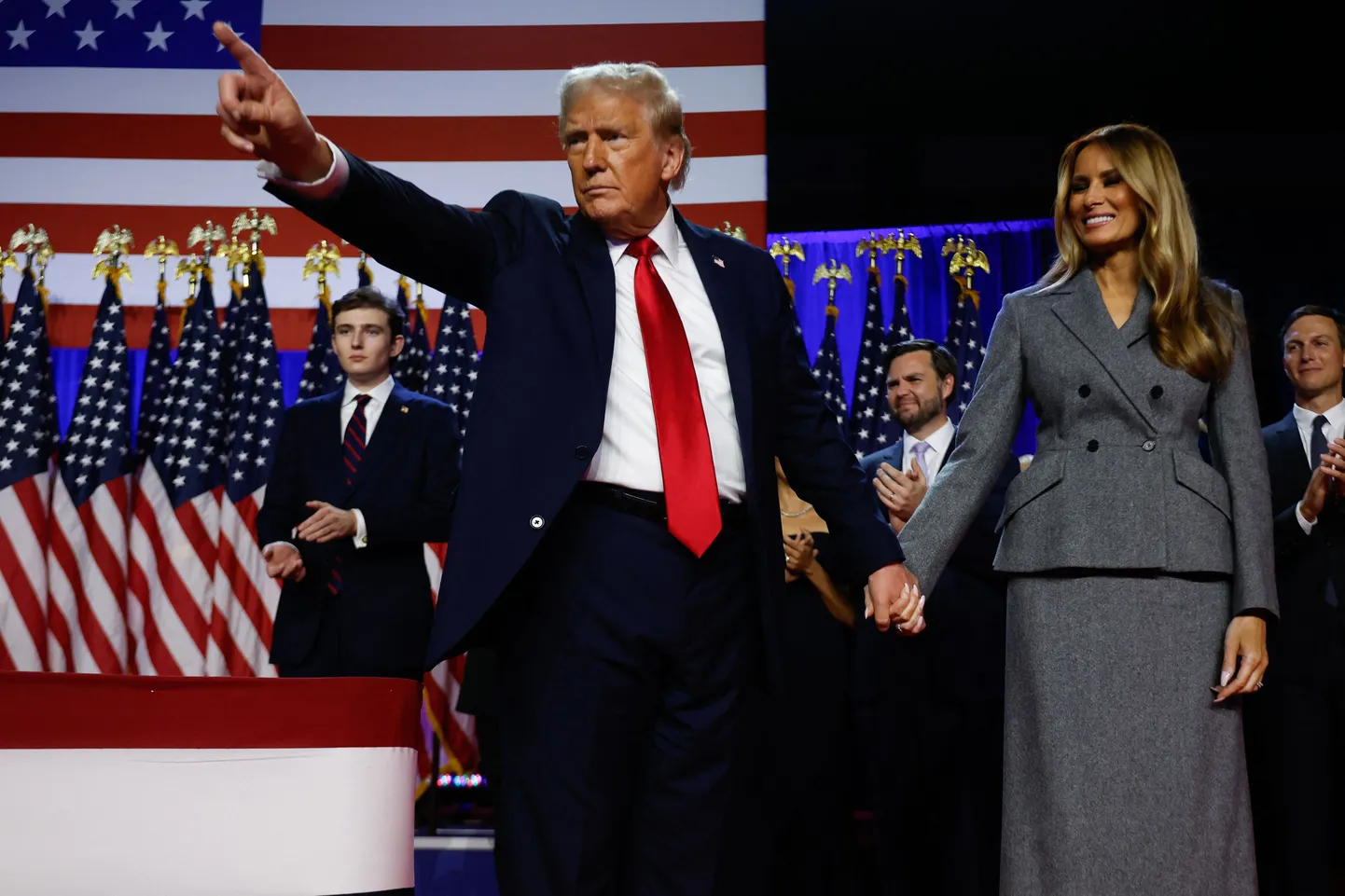 Former U.S. President Donald Trump points to supporters with former first lady Melania Trump during an election night event at the Palm Beach Convention Center on November 06, 2024 in West Palm Beach, Florida. Americans cast their ballots today in the presidential race between Republican nominee former President Donald Trump and Vice President Kamala Harris, as well as multiple state elections that will determine the balance of power in Congress.   Chip Somodevilla/Getty Images/AFP (Photo by CHIP SOMODEVILLA / GETTY IMAGES NORTH AMERICA / Getty Images via AFP)