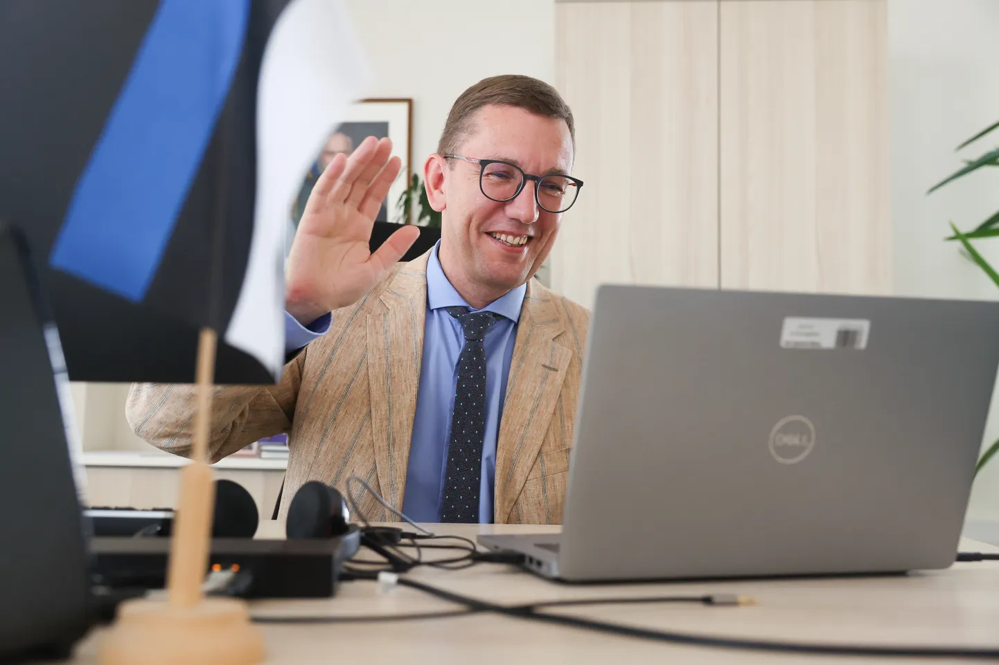 Kristen Michal waving in greeting to his party colleagues at the start of the Reform Party board meeting in his ministerial office on Friday morning.