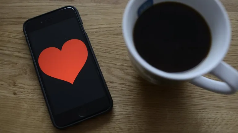 coffee and a phone with a hearth illustration on screen