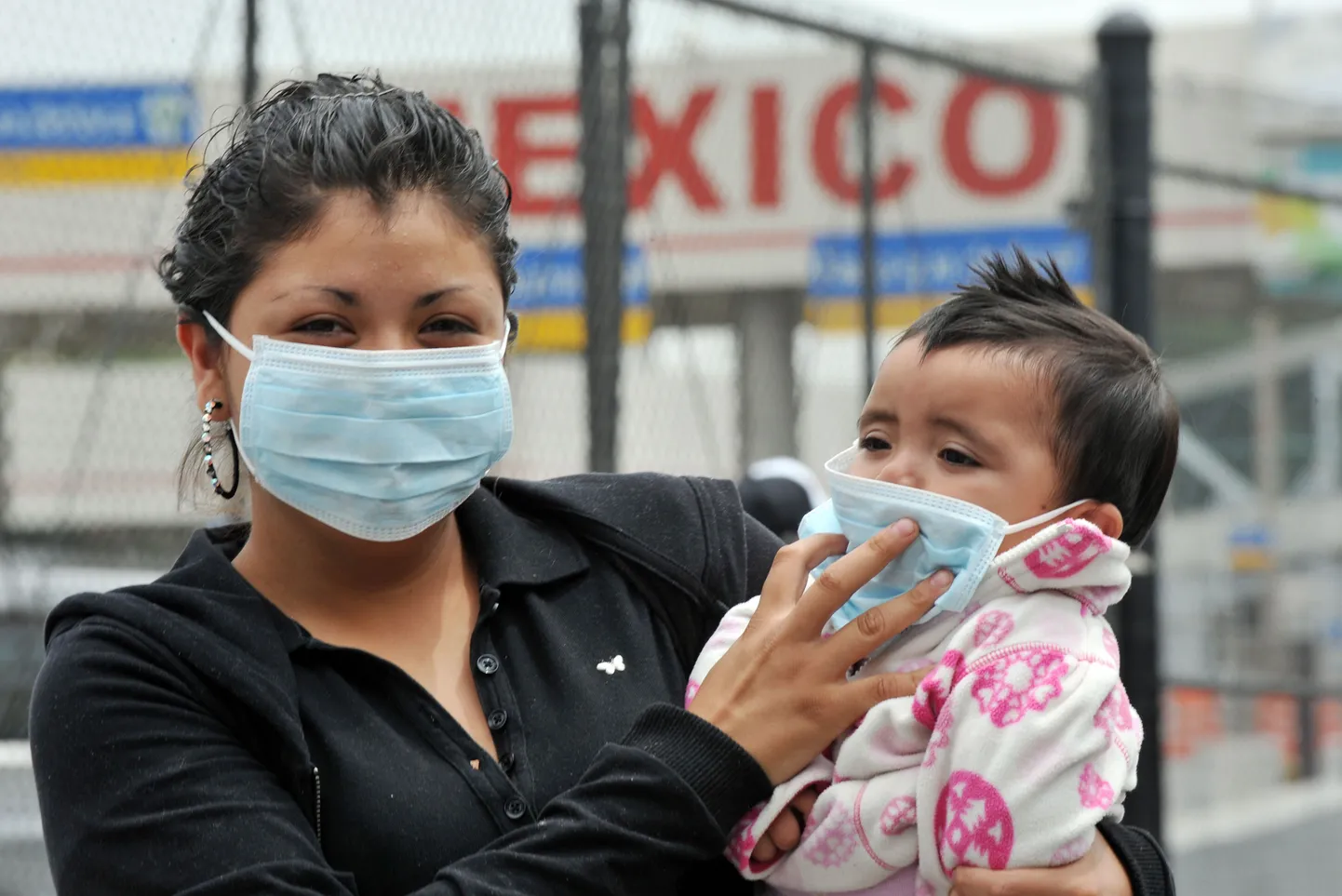 Naine koos lapsega USA-Mehhiko piiri ületamas.
