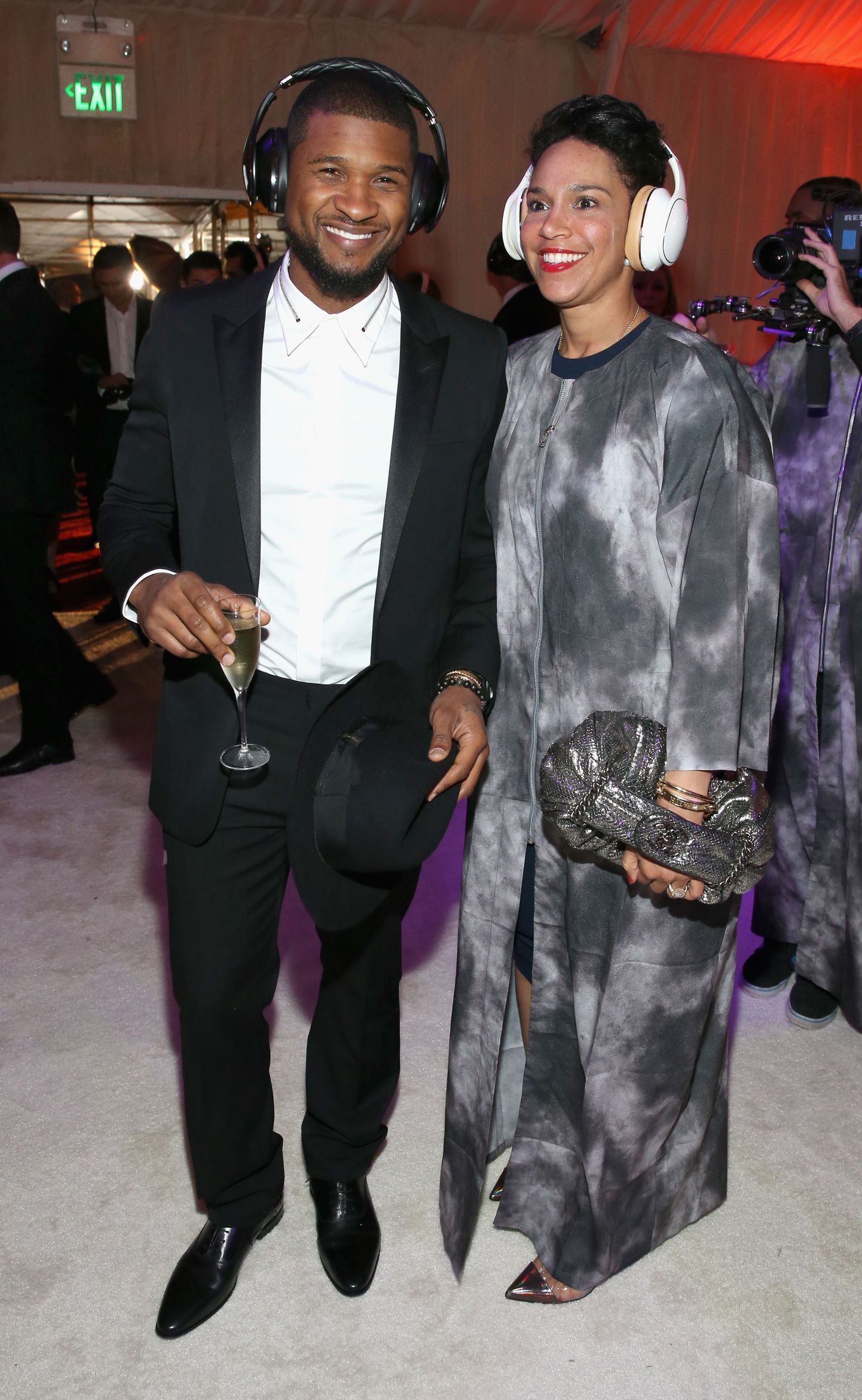 LOS ANGELES, CA - JANUARY 10: Recording artist Usher (L) and Grace Miguel, wearing Samsung Level headphones, attend the Art of Elysium and Samsung Galaxy present Marina Abramovic's HEAVEN at Hangar 8 on January 10, 2015 in Los Angeles, California.   Jonathan Leibson/Getty Images for Samsung/AFP
== FOR NEWSPAPERS, INTERNET, TELCOS & TELEVISION USE ONLY ==