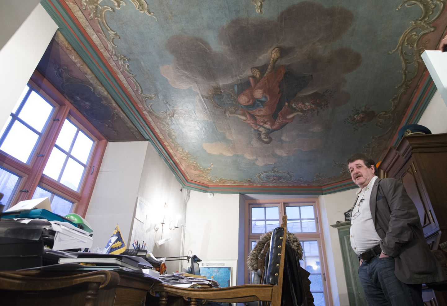 Muinsuskaitse osakonna juhataja Boris Dubovik näitab vanade maalingutega lage, mis restaureerimise käigus krohvikihtide alt välja tuli.