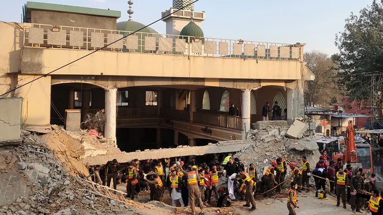 Rescue workers at the scene of a blast at a Mosque, in Peshawar, Pakistan, 30 January 2023