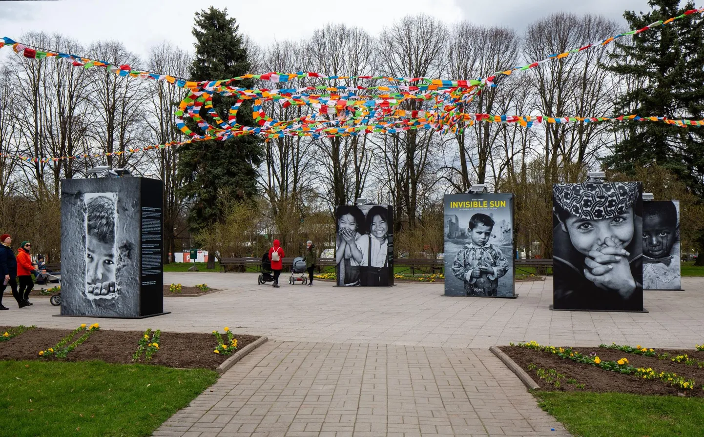 Tartu kesklinna pargis lehvivad näituse fotode ja tekstide kohal Tiibeti palvelipud.