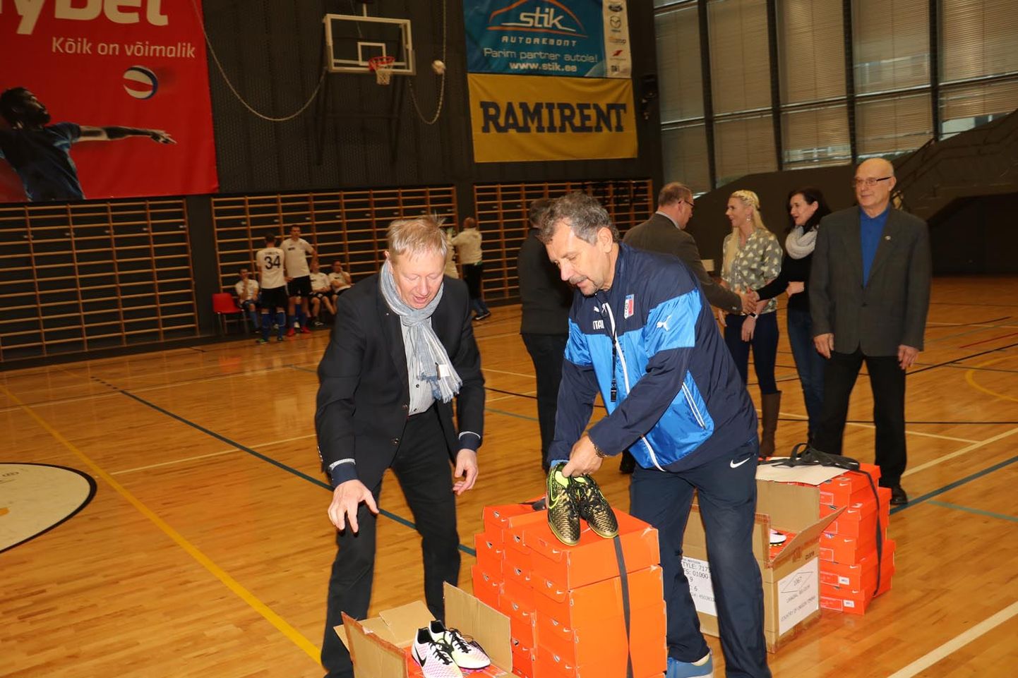 Lõviklubi Paide Bastioni president Aarne Krass (vasakul) annab jalgpallitreener Viktor Metsale ja Paide valla koolile kätte norralaste kingitud 50 paari uusi jalgpallijalatseid.