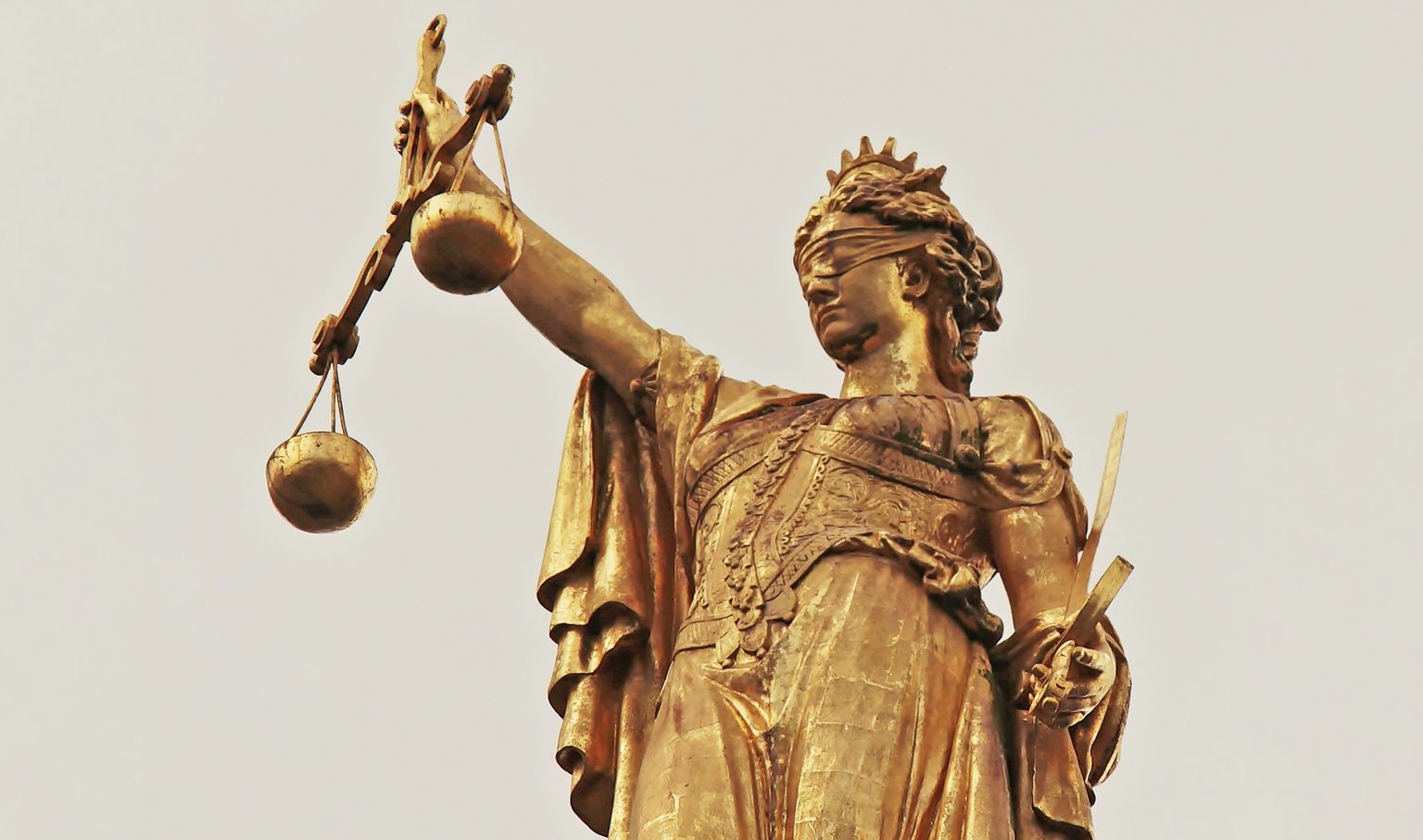 Õigusjumalanna Justiitsiat kujutatakse seotud silmadega, ühes käes mõõk, teises kaalud. Tema seotud silmad sümboliseerivad kohtumõistmise erapooletust ja allumist ainult seadusele.