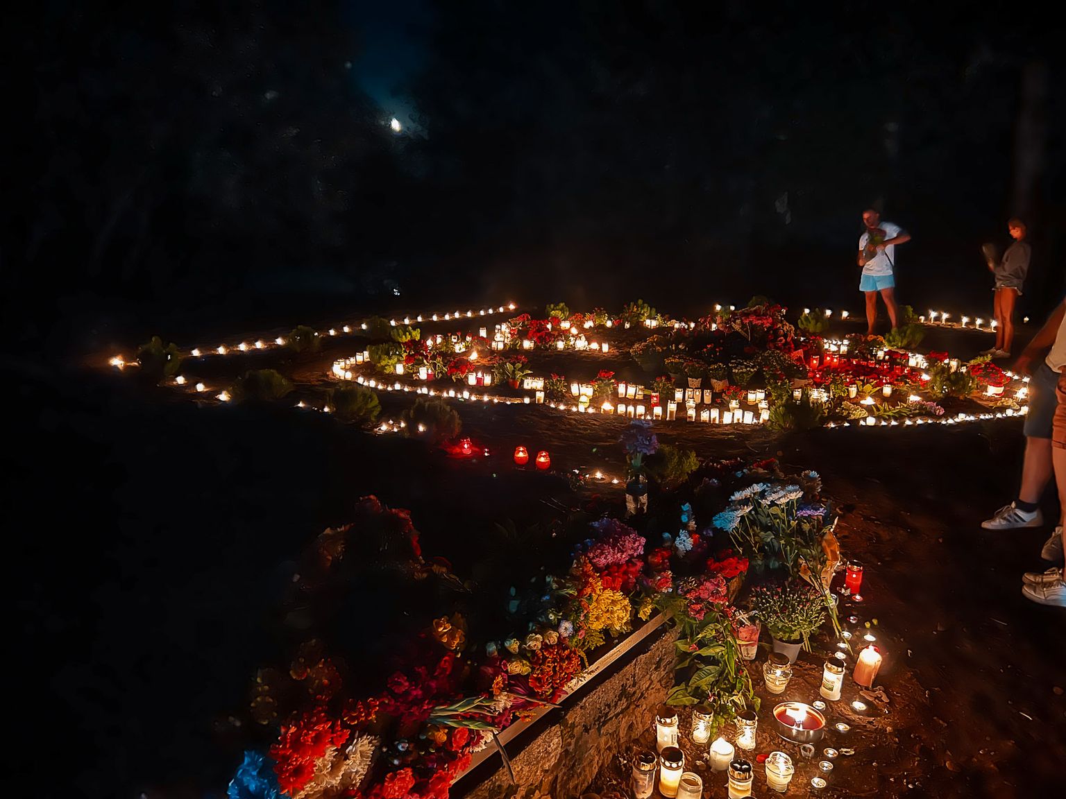 На места снесенных памятников в Нарве люди с вечера и до глубокой ночи приносили свечи и цветы.