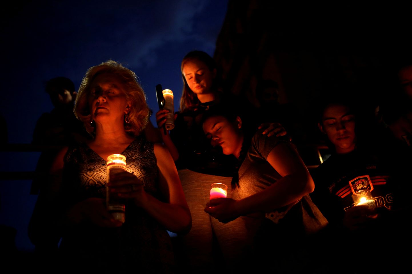 Mourners taking part in a vigil at El Paso High School after a mass shooting at a Walmart store in El Paso, Texas, U.S. August 3, 2019. REUTERS/Jose Luis Gonzalez     TPX IMAGES OF THE DAY