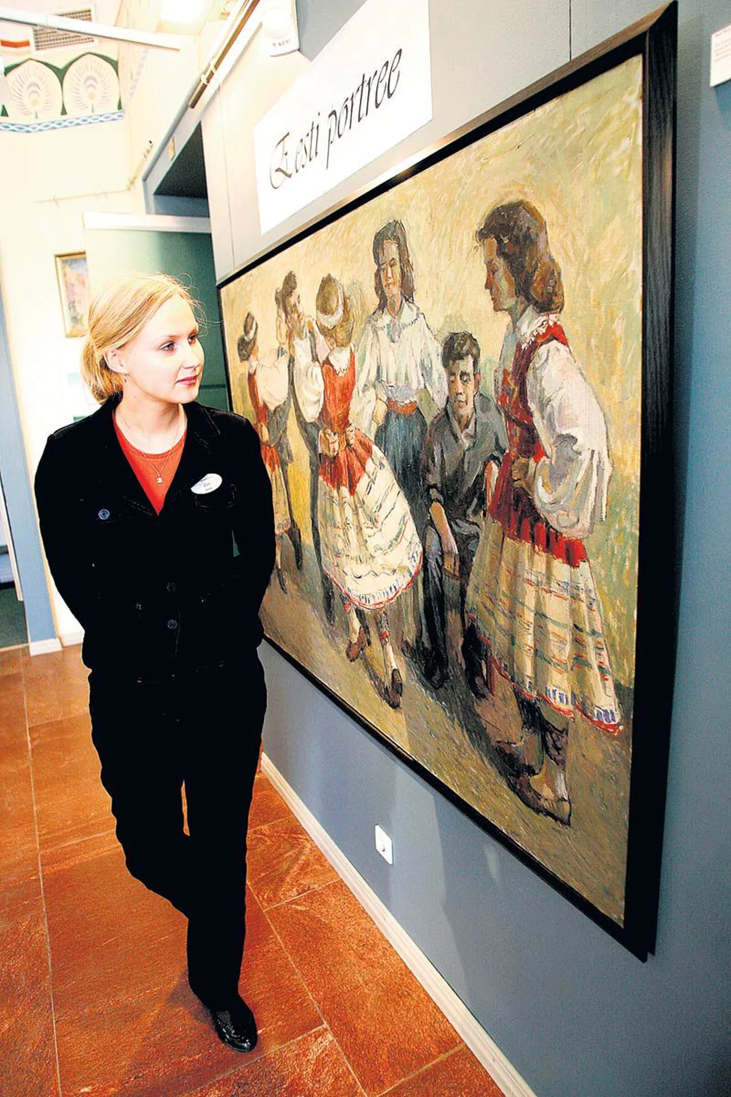 Galerist Elen Soe ees on Mati Ruljandi maal, millel kujutatud istuv mees on ilmselt kunstnik Elmar Kits.
