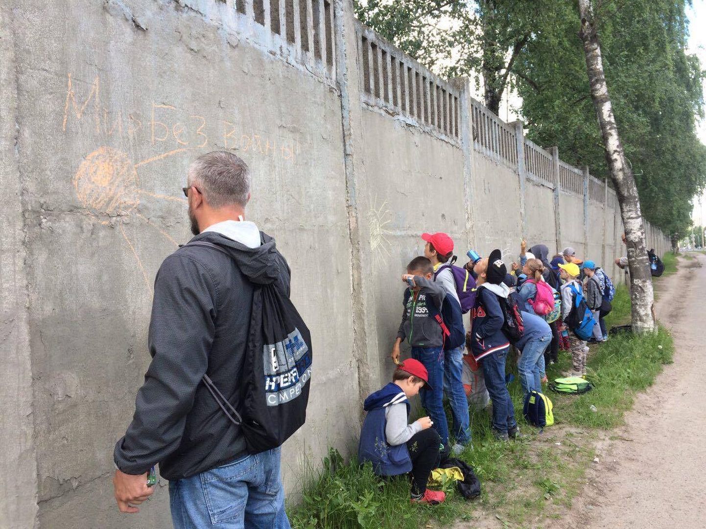 FSB kaastöötaja Petrov hoolealustega mullu 22. juunil Pihkva dessantdiviisi staabi seinale rahusõnumeid joonistamas. Nüüd ütleb ta, et aiale joonistamine oli üksnes tagajärg.