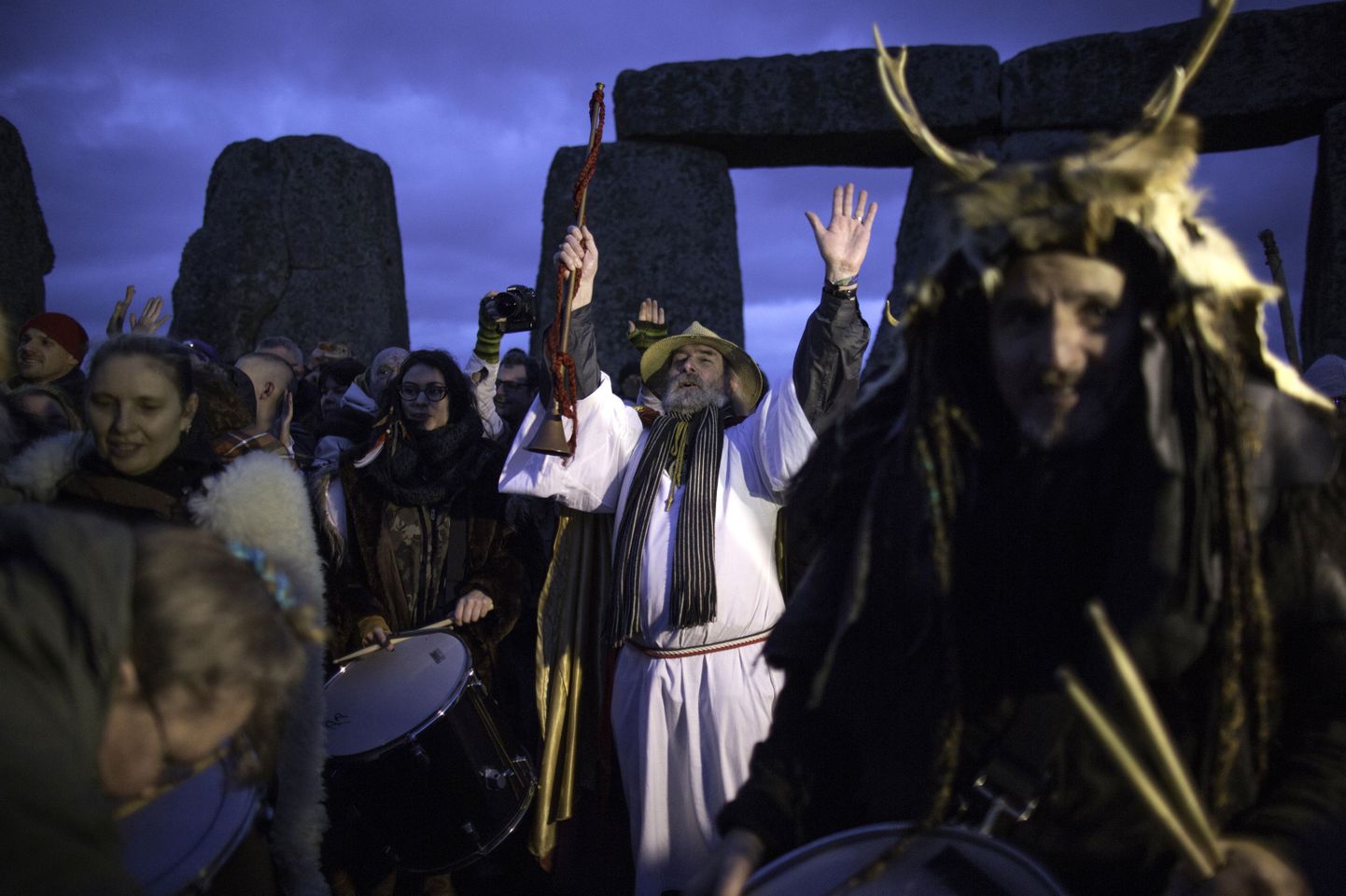 Revellers celebrate the winter solstice at Stonehenge on Salisbury Plain in southern England December 22, 2015. Stonehenge is a celebrated venue of festivities during the winter solstice - the shortest day of the year in the northern hemisphere - and it attracts thousands of revellers, spiritualists and tourists. Druids, a pagan religious order dating back to Celtic Britain, believe Stonehenge was a centre of spiritualism more than 2,000 years ago.  REUTERS/Kieran Doherty TPX IMAGES OF THE DAY