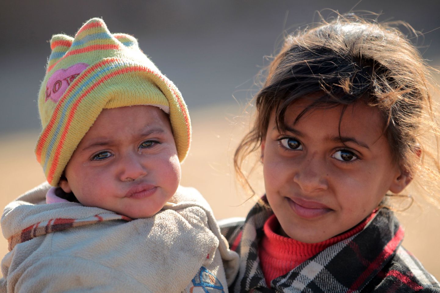 Displaced Iraqi children, from the outskirts of the city of Tal Afar, pose at a makeshift camp on December 12, 2016 in the village of Khalif Saleh, south of Tal Afar, where their family found refuge as Iraqi forces continue their assault to eject Islamic State (IS) group jihadists from Mosul, their last Iraqi stronghold.
The Hashed al-Shaabi forces have been fighting on a western front, in a campaign aimed at retaking the town of Tal-Afar and cutting IS supply lines between Mosul and Syria. / AFP PHOTO / AHMAD AL-RUBAYE