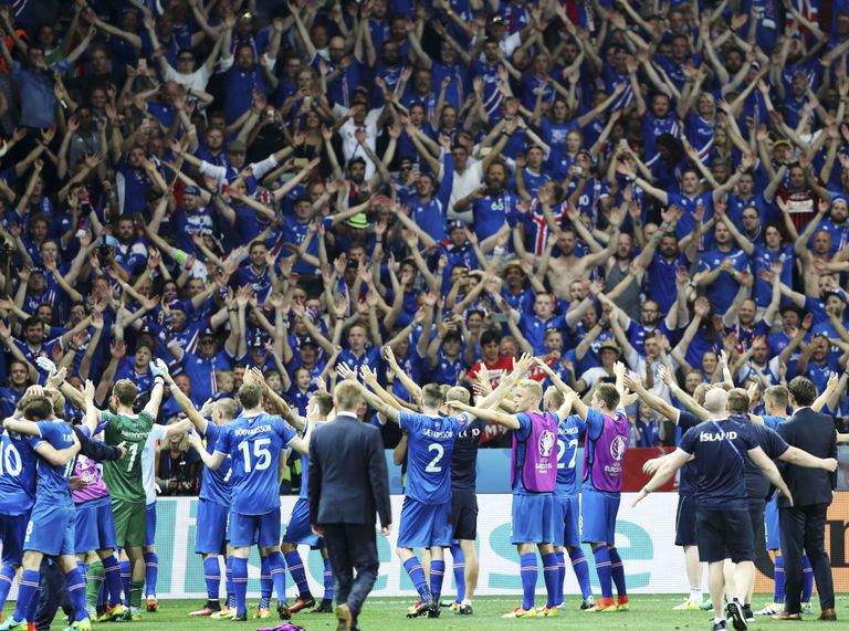 Iceland players celebrate with the supporters at the end of the Euro 2016 round of 16 soccer match between England and Iceland, at the Allianz Riviera stadium in Nice, France, Monday, June 27, 2016. (AP Photo/Claude Paris)