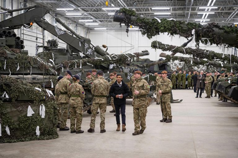 British Prime Minister cheerfully exchanging courtesies with the soldiers.
