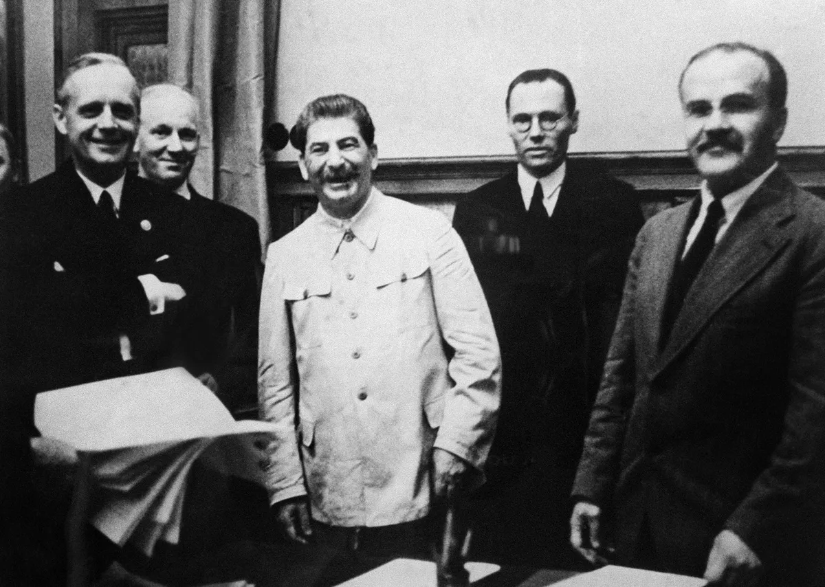 Nazi Germany's Foreign Minister Joachim von Ribbentrop (front row, from left to right), Soviet dictator Joseph Stalin, and his Foreign Minister Vyacheslav Molotov in the Kremlin on August 23, 1939, after signing the Soviet-German agreements.