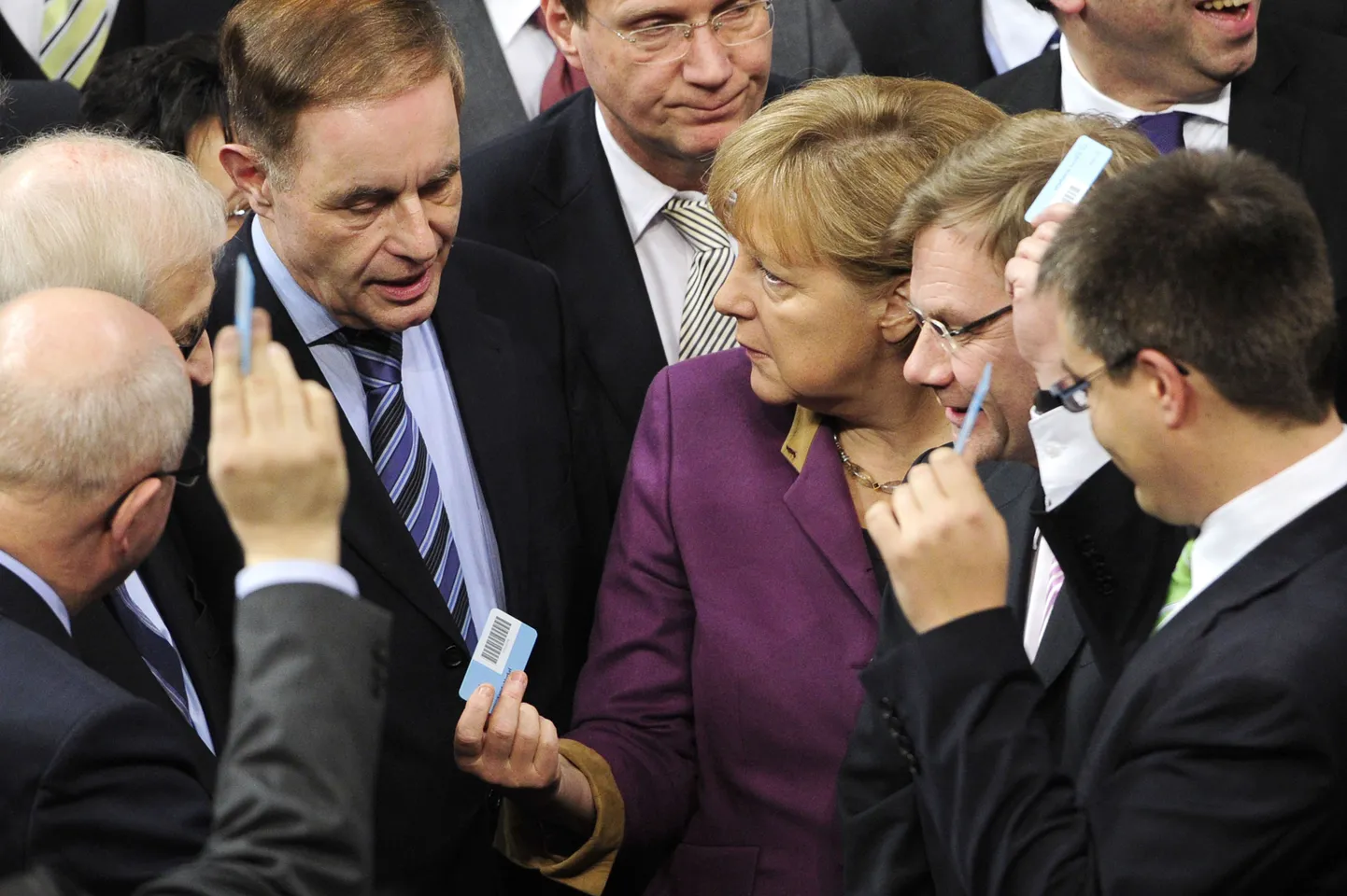 Parlamendiliikmetest ümbritsetud Saksamaa liidukantsler Angela Merkel täna hääletussedelit ära andmas.