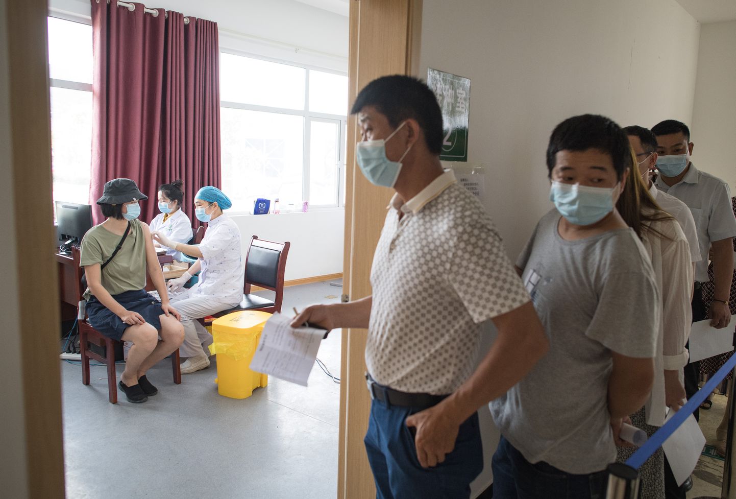 Inimesed ootamas Wuhanis koroonavaktsiini järjekorras.