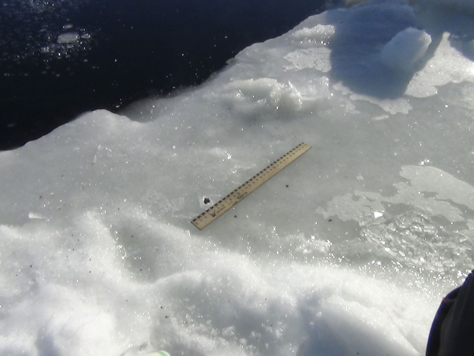 Mõõdulint meteoriiditükikese kõrval Tšebarkuli järve katval jääl.