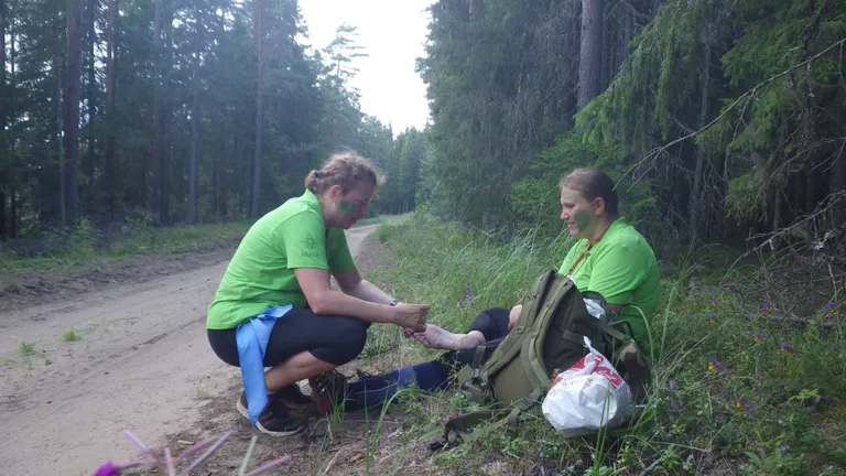 Loo autor plaasterdab Liisi Laasiku varbaid. Märjad jalad on villidele soodne pinnas.